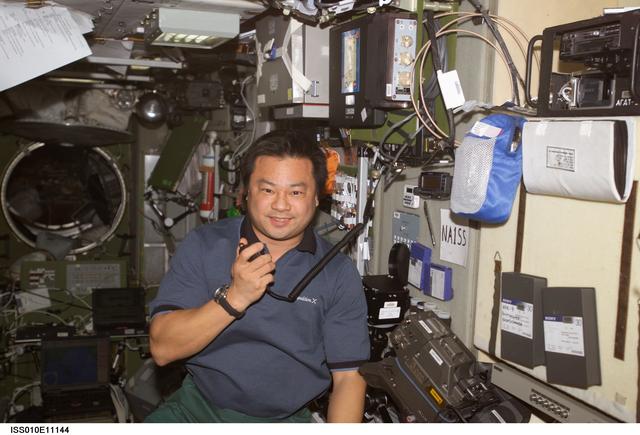 NASA image: Chiao uses a handheld communicator in the SM during Expedition 10