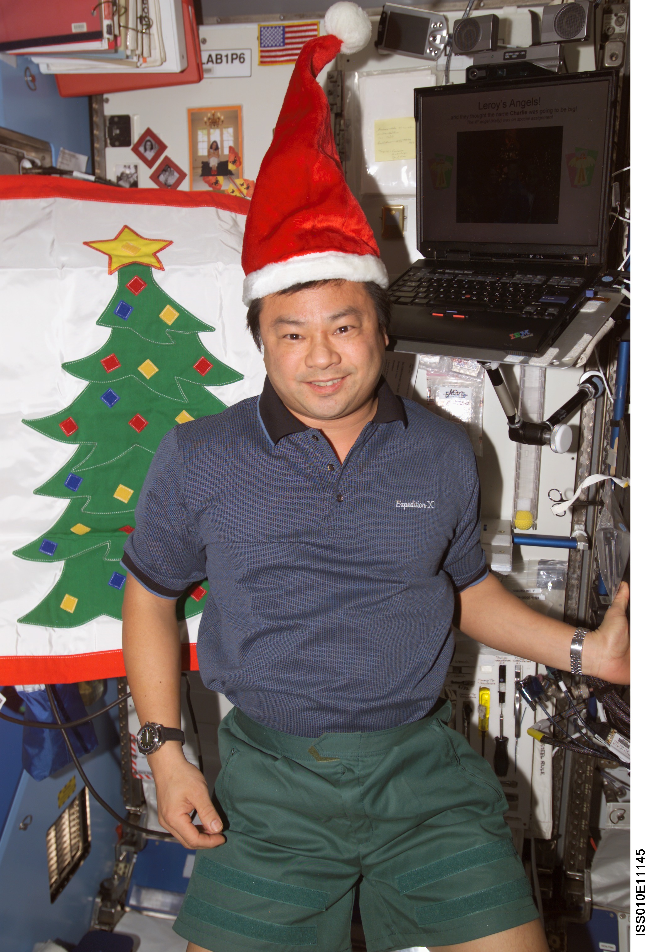 ISS010-E-11145 (16 December 2004) --- Astronaut Leroy Chiao, Expedition 10 commander and NASA ISS science officer, poses with holiday decorations in the Destiny laboratory of the International Space Station (ISS).