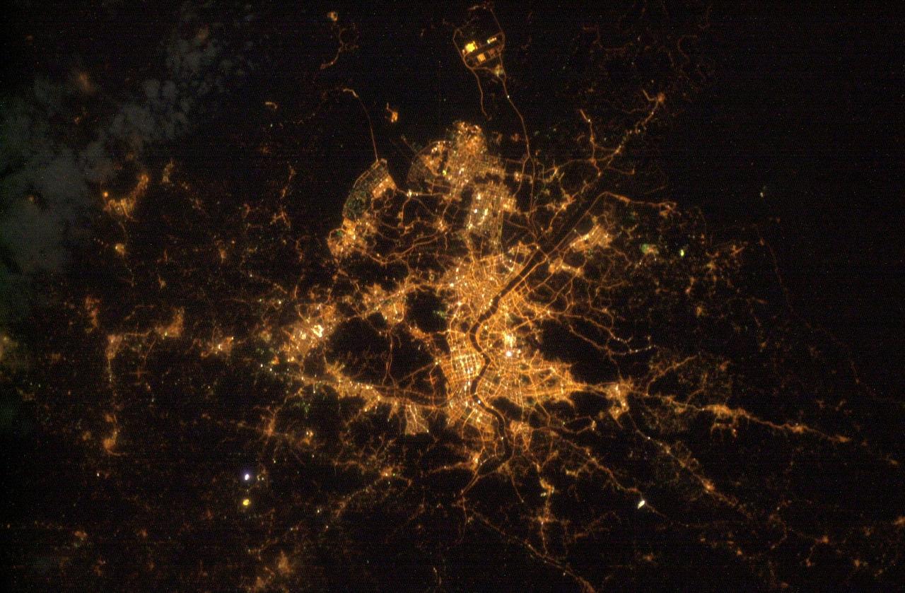 ISS010-E-12103 (25 December 2004) --- Seoul, South Korea is featured in this digital image photographed by an Expedition 10 crewmember on the International Space Station. This photograph illustrates the Seoul (originally known as Hanyang) urban area at night. Major roadways and river courses (such as the Han River) are clearly outlined by street lights, while the brightest lights indicate the downtown urban core (center of image) and large industrial complexes. Very dark regions in the image are mountains or large bodies of water.