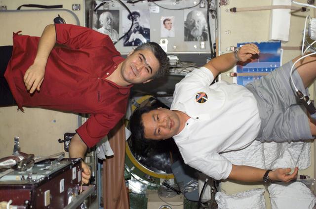 NASA image: Sharipov and Chiao pose in the SM taken during Expedition 10