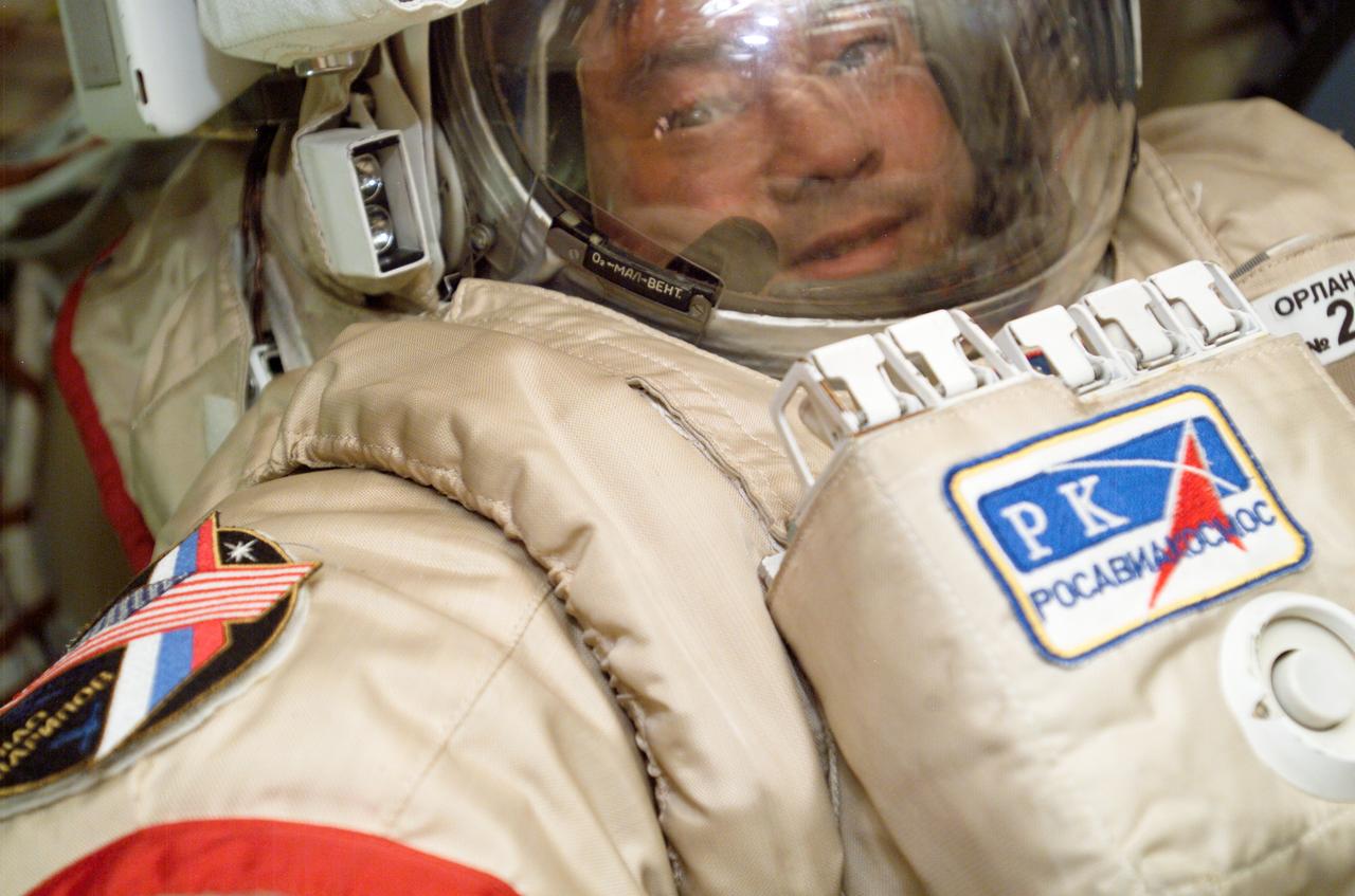 ISS010-E-14778 (24 January 2005) --- Astronaut Leroy Chiao, Expedition 10 commander and NASA Space Station science officer, prepares for January 26 extravehicular activity -- one of two planned Expedition 10 spacewalks. He is in the Pirs Docking Compartment on the orbiting complex.
