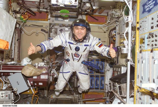 NASA image: Sharipov wearing Sokol suit poses for photo in SM taken during Expedition 10