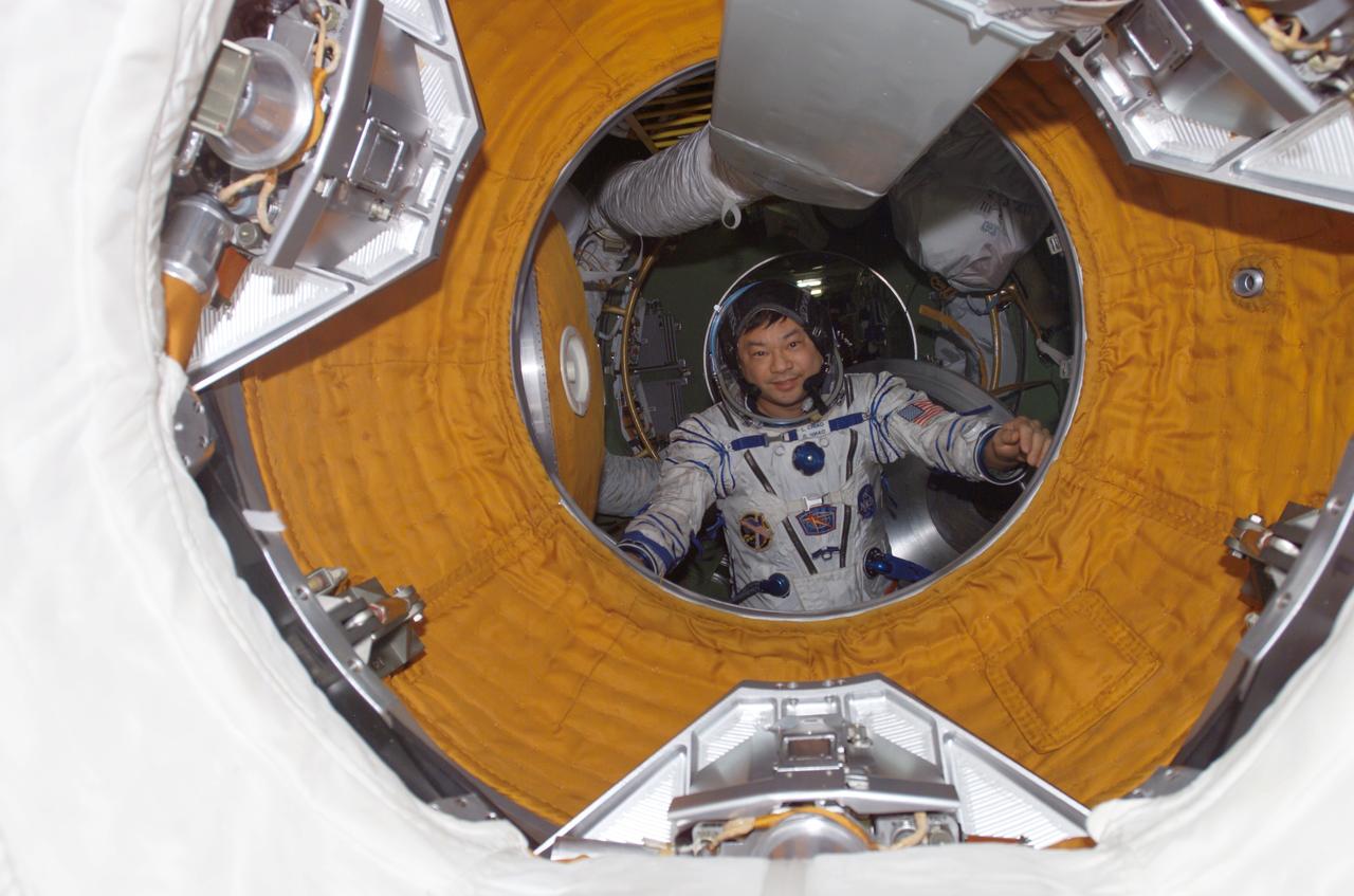 ISS010-E-15374 (1 February 2005) --- Astronaut Leroy Chiao, Expedition 10 commander and Space Station science officer, is positioned at the hatchway of the Zvezda Service Module. Chiao is wearing a Russian Sokol suit.