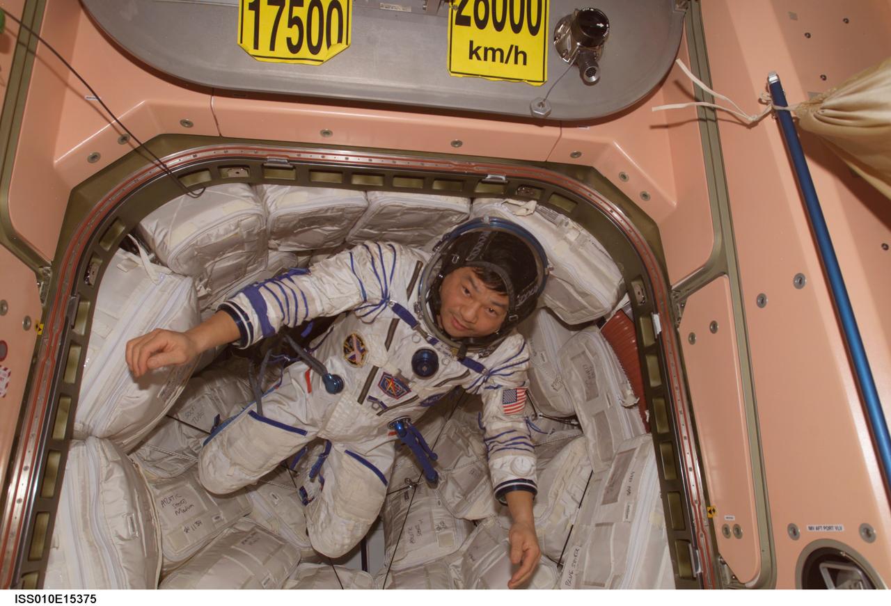 ISS010-E-15375 (1 February 2005) --- Wearing a Russian Sokol suit, astronaut Leroy Chiao, Expedition 10 commander and NASA ISS science officer, floats in a hatch in the Unity node of the International Space Station (ISS).