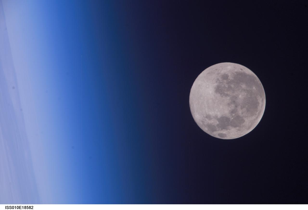 ISS010-E-18582 (24 February 2005) --- A full moon is visible in this view above Earth&#0146;s horizon and airglow, photographed by an Expedition 10 crewmember on the International Space Station (ISS).