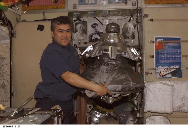 NASA image: Sharipov holds the probe-and-cone docking mechanism in the SM during Expedition 10