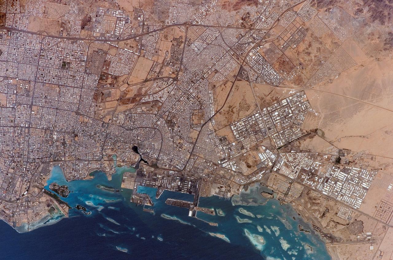 ISS010-E-20261 (19 March 2005) --- Jeddah, Saudi Arabia is featured in this image photographed by an Expedition 10 crewmember on the International Space Station. The city of Jeddah is the second largest city in Saudi Arabia (after Riyadh), and is the country&#0146;s most important Red Sea port. A large warehouse and dock complex is visible in the lower left portion of this image. Apart from being a major port for exchange of goods with Africa and Europe, Jeddah is of great importance for Islamic pilgrims going east to Mecca (a religious journey known as the hajj). In addition to urban attractions, coral reefs along the coast (north-south trending islands to image left) are frequented by divers visiting the city. The image captures the multicolored rooftops of homes and other buildings in the city, the oldest of which were built using coral from the nearby Red Sea and clay from the al-Manqabah lagoon in the center of the Al Balad district (center of image; lagoon is approximately 0.25 km across).