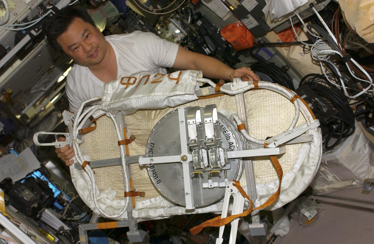 ISS010-E-20762 (21 March 2005) --- Astronaut Leroy Chiao, Expedition 10 commander and NASA ISS science officer, works with a Global Positioning System (GPS) Unit in the Zvezda Service Module of the International Space Station (ISS).