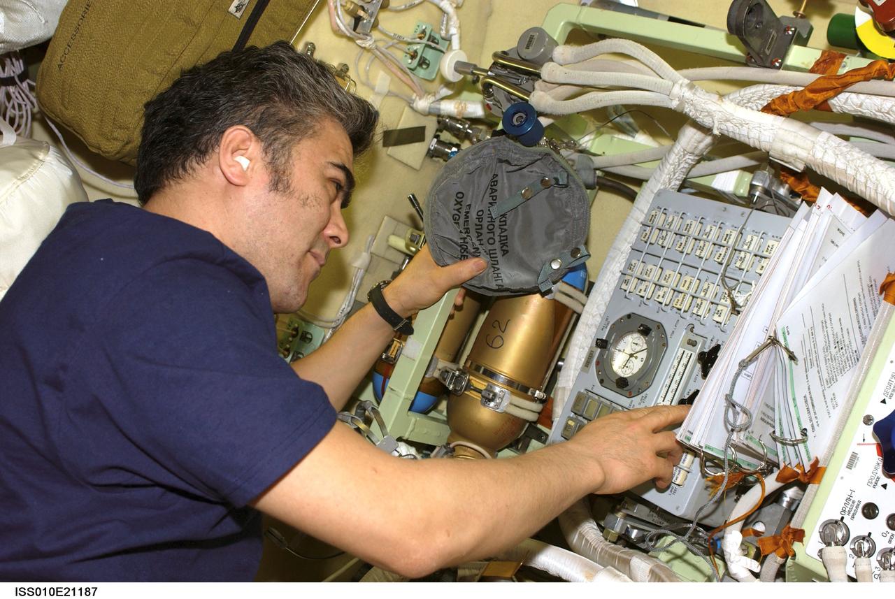 ISS010-E-21187 (23 March 2005) --- Cosmonaut Salizhan S. Sharipov, Expedition 10 flight engineer representing Russia's Federal Space Agency, works with the Russian Orlan Interface Unit in the Pirs Docking Compartment of the International Space Station (ISS). The final spacewalk for Expedition 10 is scheduled for March 28.