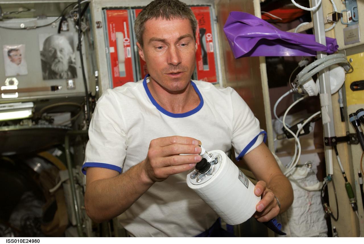 ISS010-E-24980 (18 April 2005) --- Cosmonaut Sergei K. Krikalev, Expedition 11 commander representing Russia's Federal Space Agency, holds a sample tube within the Commercial Protein Crystallization Facility-2 (CPCF-2) Activation Mechanism which is part of the Kriogem-03 refrigerator in the Zvezda Service Module of the International Space Station (ISS).