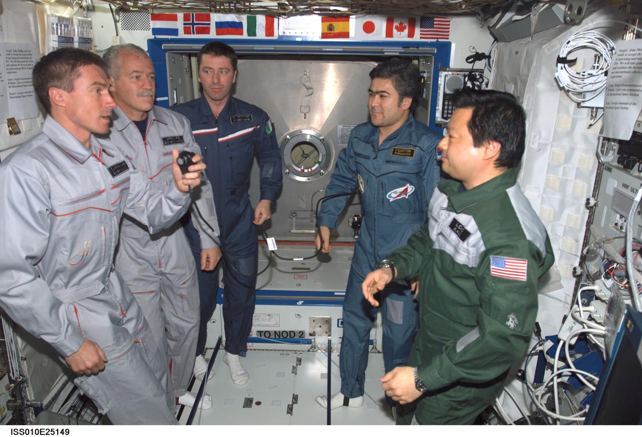 ISS010-E-25149 (22 April 2005) --- The crewmembers onboard the International Space Station (ISS) gather in the Destiny laboratory for the ceremony of Changing-of-Command from Expedition 10 to Expedition 11. From the right are astronaut Leroy Chiao, Expedition 10 commander and NASA ISS science officer; cosmonaut Salizhan S. Sharipov, Expedition 10 flight engineer representing Russia's Federal Space Agency; European Space Agency (ESA) astronaut Roberto Vittori of Italy; astronaut John L. Phillips, Expedition 11 NASA ISS science officer and flight engineer; and cosmonaut Sergei K. Krikalev, Expedition 11 commander representing Russia's Federal Space Agency.