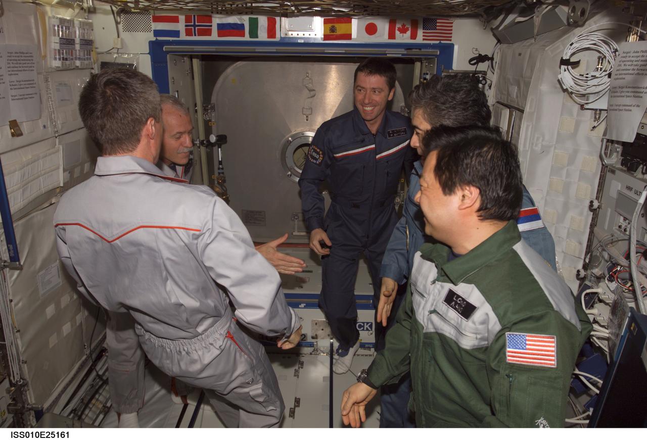 ISS010-E-25161 (22 April 2005) --- The crewmembers onboard the International Space Station (ISS) exchange greetings in the Destiny laboratory following the ceremony of Changing-of-Command from Expedition 10 to Expedition 11. From the left are cosmonaut Sergei K. Krikalev, Expedition 11 commander representing Russia's Federal Space Agency; astronaut John L. Phillips, Expedition 11 NASA ISS science officer and flight engineer; European Space Agency (ESA) astronaut Roberto Vittori of Italy; cosmonaut Salizhan S. Sharipov, Expedition 10 flight engineer representing Russia's Federal Space Agency; and astronaut Leroy Chiao, Expedition 10 commander and NASA ISS science officer.