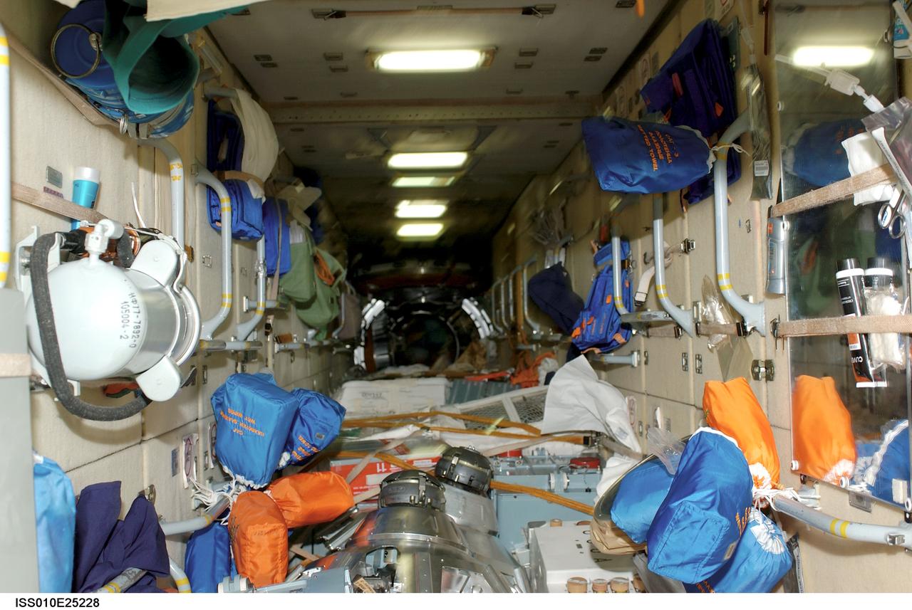 ISS010-E-25228 (20 April 2005) --- This view shows supplies and equipment stowed in the functional cargo block (FGB) or Zarya photographed by a crewmember on the International Space Station (ISS). At the time this photo was taken the Expedition 10 and 11 crews were onboard the Station.