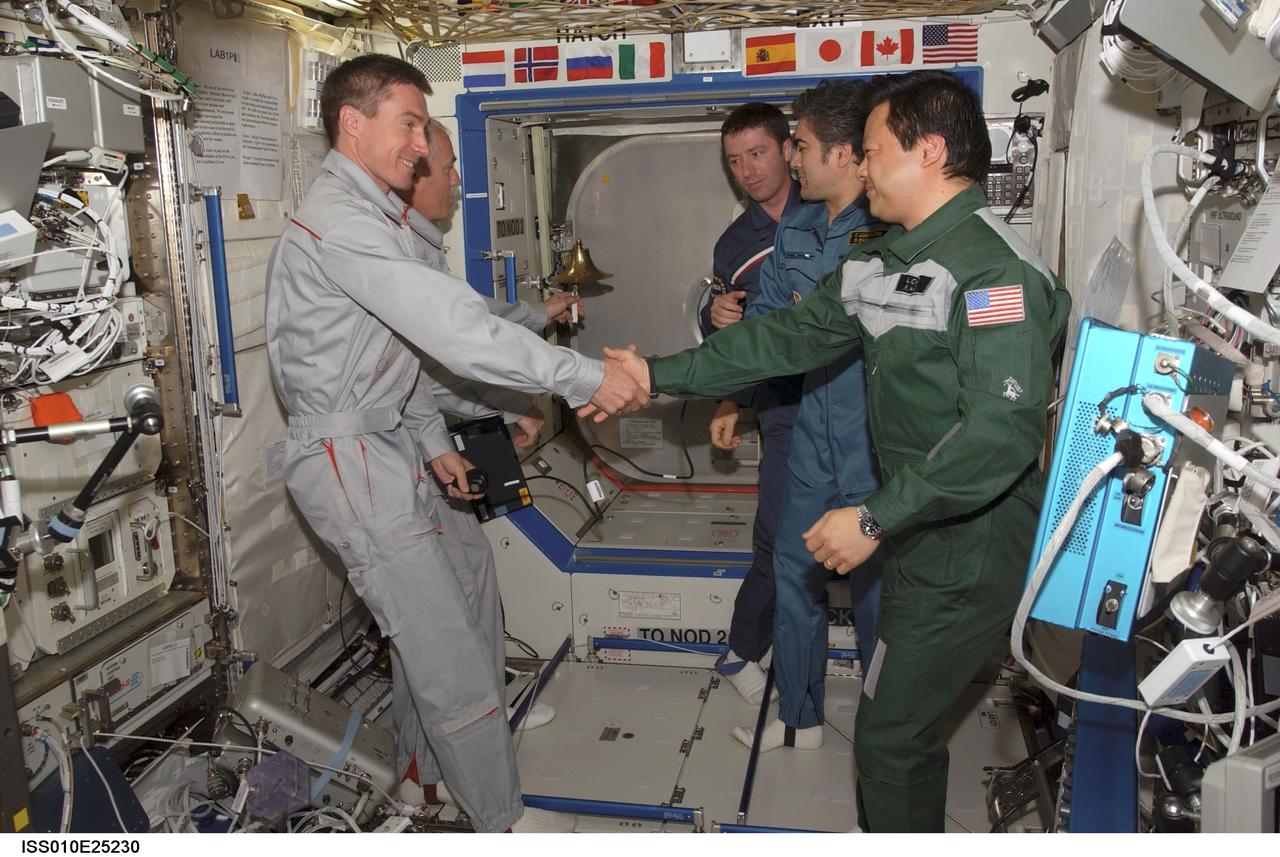 ISS010-E-25230 (22 April 2005) --- The crewmembers onboard the International Space Station (ISS) exchange greetings in the Destiny laboratory following the ceremony of Changing-of-Command from Expedition 10 to Expedition 11. From the left are cosmonaut Sergei K. Krikalev, Expedition 11 commander representing Russia's Federal Space Agency; astronaut John L. Phillips, Expedition 11 NASA ISS science officer and flight engineer; European Space Agency (ESA) astronaut Roberto Vittori of Italy; cosmonaut Salizhan S. Sharipov, Expedition 10 flight engineer representing Russia's Federal Space Agency; and astronaut Leroy Chiao, Expedition 10 commander and NASA ISS science officer.