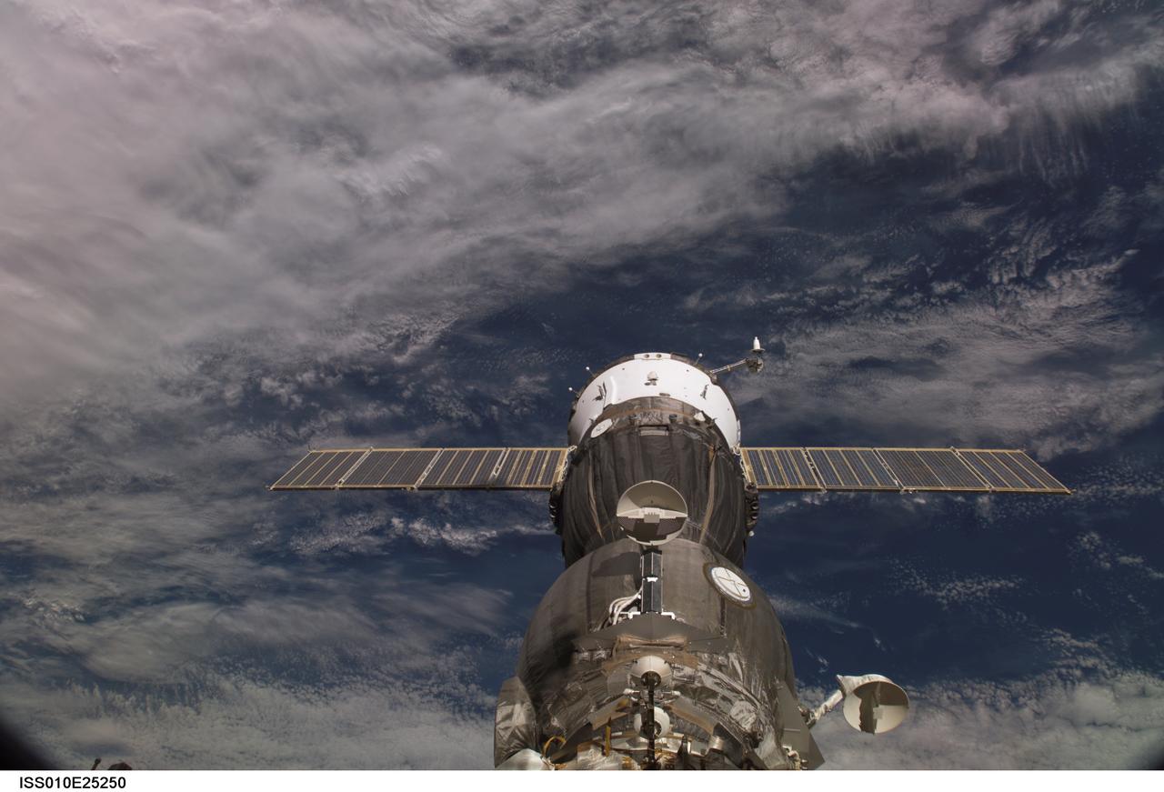 ISS010-E-25250 (18 April 2005) --- A blanket of clouds provides the backdrop for this scene of the Soyuz TMA-6 spacecraft, docked to the Pirs Docking Compartment on the International Space Station (ISS). The scene was photographed by an Expedition 10 crewmember.