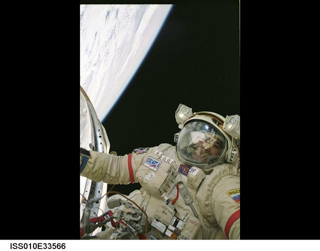 ISS010-E-33566 (26 January 2005) --- Cosmonaut Salizhan S. Sharipov, Expedition 10 flight engineer representing Russia's Federal Space Agency, wearing a Russian Orlan spacesuit, participates in the first of two sessions of extravehicular activities (EVA) performed by the Expedition 10 crew during their six-month mission. Sharipov and astronaut Leroy Chiao (out of frame), mission commander and NASA ISS science officer, spent 5 ½ hours outside the International Space Station (ISS) installing a work platform, cables and robotic and scientific experiments on the exterior of the Zvezda Service Module. Earth’s horizon and the blackness of space provided the backdrop for the image.