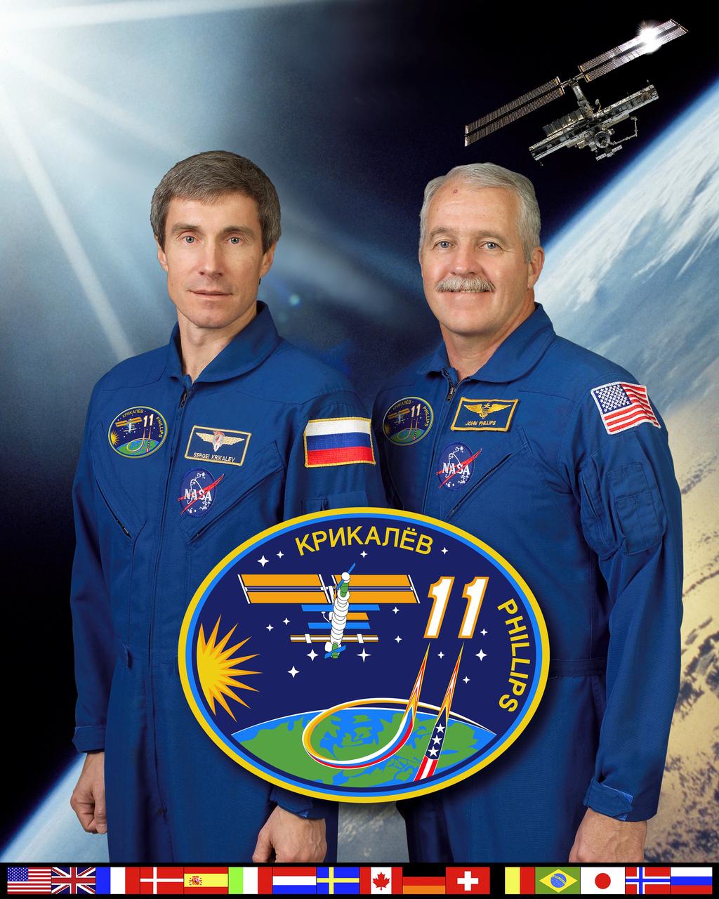 ISS011-S-002 (17 February 2005) --- Cosmonaut Sergei K. Krikalev (left), Expedition 11 commander representing Russia's Federal Space Agency; and astronaut John L. Phillips, NASA ISS science officer and flight engineer, pause from their training schedule for a crew portrait at Johnson Space Center (JSC). The two will be launched to the International Space Station (ISS) in early spring of this year in a Soyuz TMA-6 spacecraft.