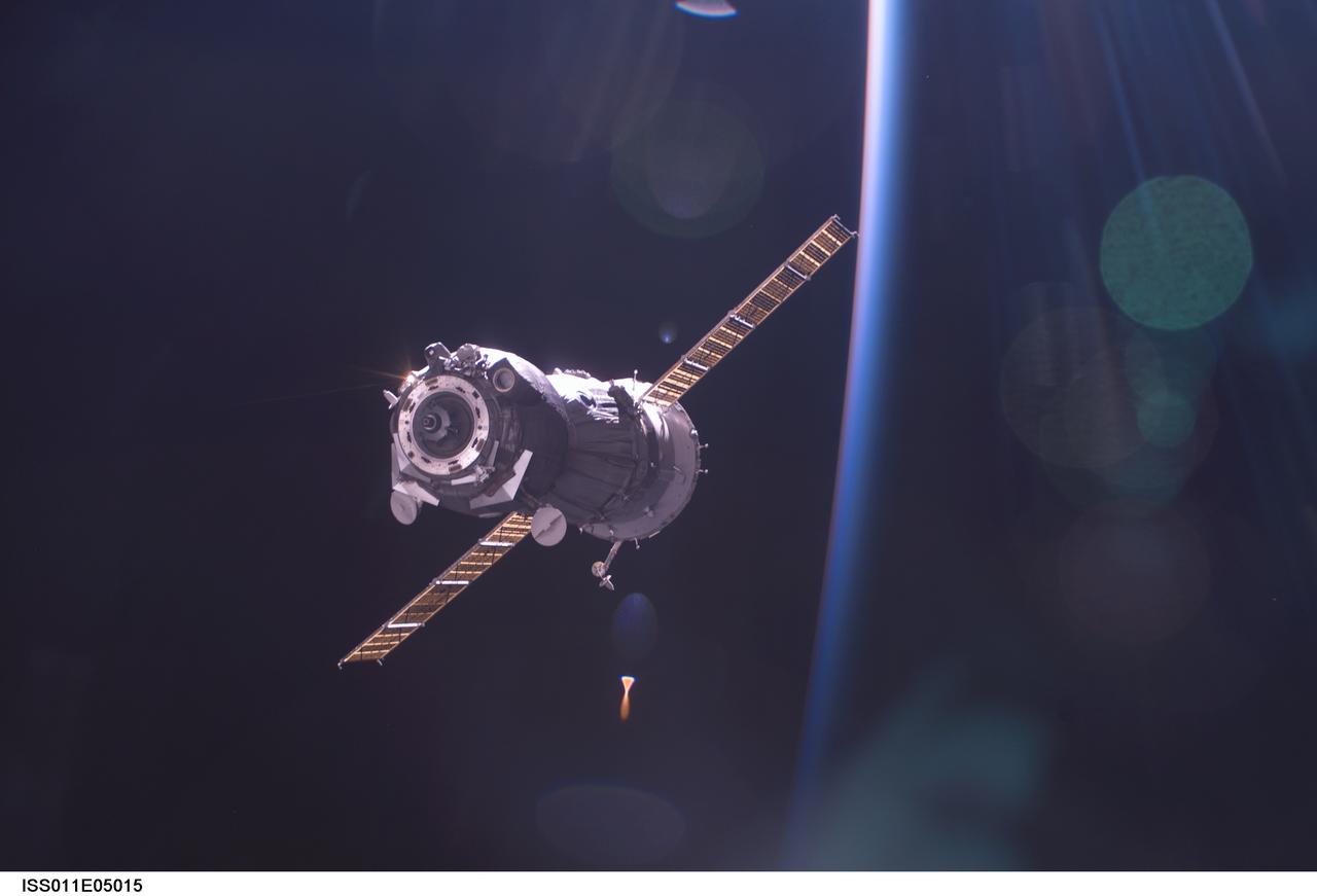 ISS011-E-05015 (24 April 2005) --- Backdropped by the blackness of space and airglow of Earth&#0146;s horizon, the Soyuz TMA-5 spacecraft departs from the International Space Station (ISS) carrying astronaut Leroy Chiao, Expedition 10 commander and NASA ISS science officer; cosmonaut Salizhan S. Sharipov, flight engineer representing Russia's Federal Space Agency; and European Space Agency (ESA) astronaut Roberto Vittori of Italy. Undocking occurred at 1:41 p.m. (CDT) on April 24.