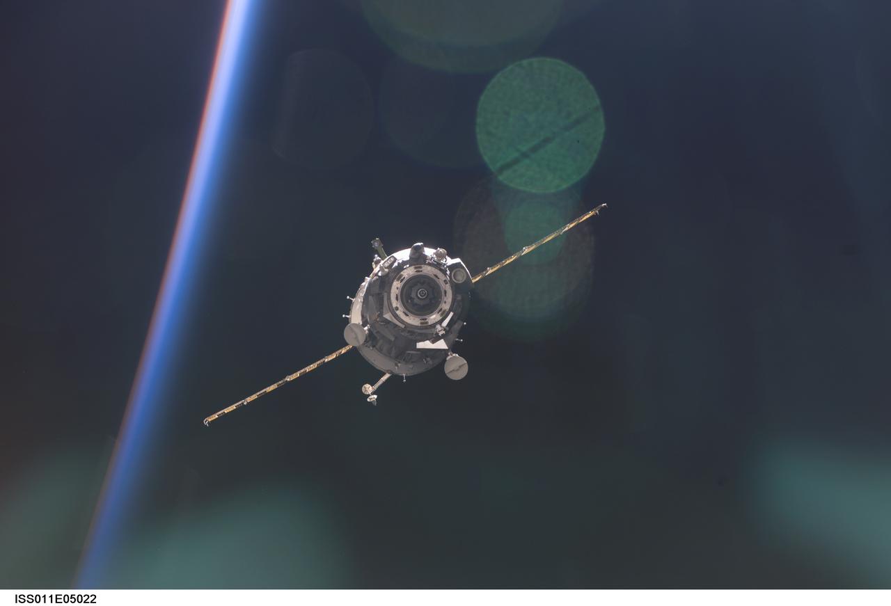 ISS011-E-05022 (24 April 2005) --- Backdropped by the blackness of space and airglow of Earth&#0146;s horizon, the Soyuz TMA-5 spacecraft departs from the International Space Station (ISS) carrying astronaut Leroy Chiao, Expedition 10 commander and NASA ISS science officer; cosmonaut Salizhan S. Sharipov, flight engineer representing Russia's Federal Space Agency; and European Space Agency (ESA) astronaut Roberto Vittori of Italy. Undocking occurred at 1:41 p.m. (CDT) on April 24.