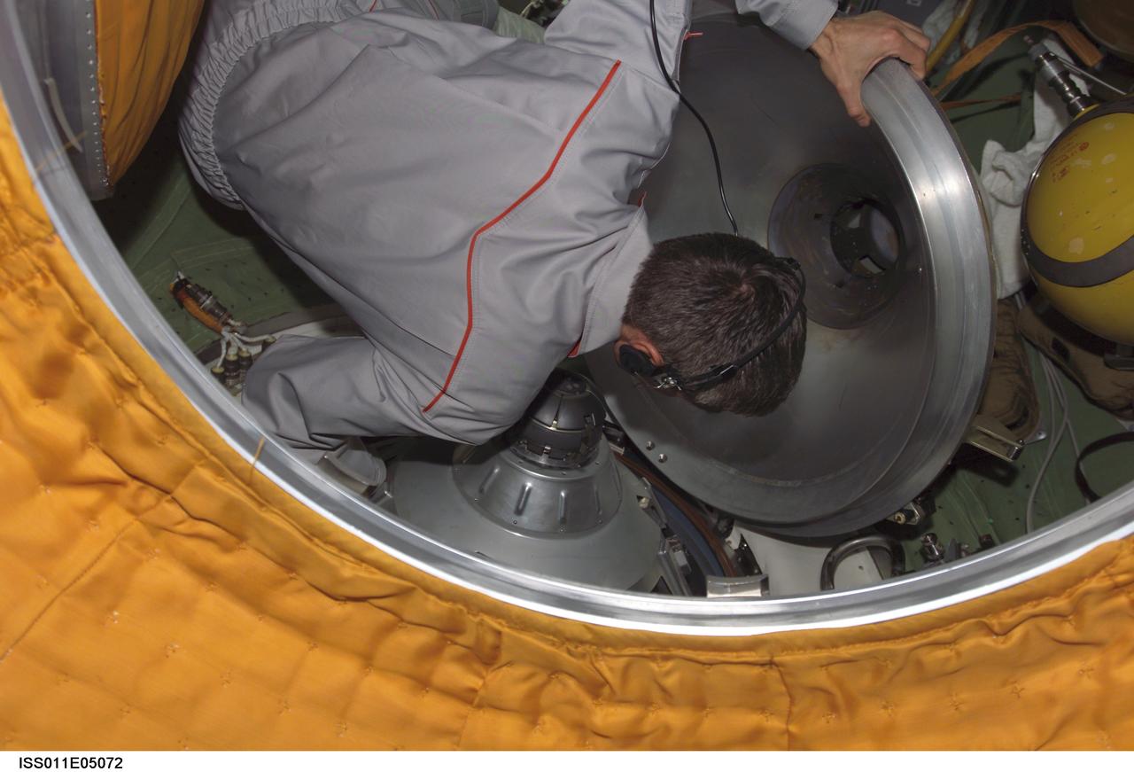 ISS011-E-05072 (24 April 2005) --- Cosmonaut Sergei K. Krikalev, Expedition 11 commander representing Russia's Federal Space Agency, closes the hatch to the Soyuz TMA-5 spacecraft docked to the International Space Station (ISS). Onboard the Soyuz are astronaut Leroy Chiao, Expedition 10 commander and NASA ISS science officer; cosmonaut Salizhan S. Sharipov, flight engineer representing Russia's Federal Space Agency; and European Space Agency (ESA) astronaut Roberto Vittori of Italy. Undocking occurred at 1:41 p.m. (CDT) on April 24.