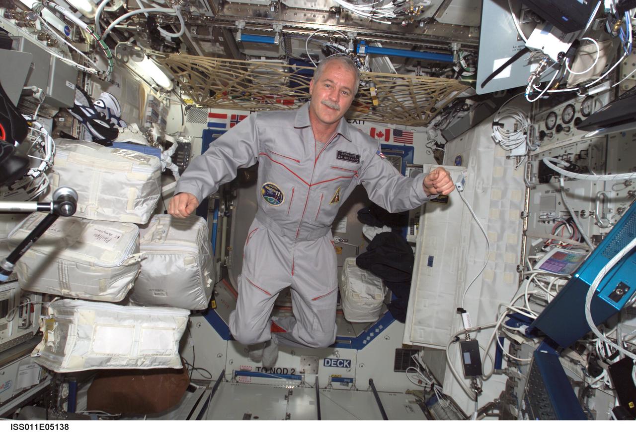 ISS011-E-05138 (17 April 2005) --- Astronaut John L. Phillips, Expedition 11 NASA ISS science officer and flight engineer, floats in the Destiny laboratory of the International Space Station (ISS).