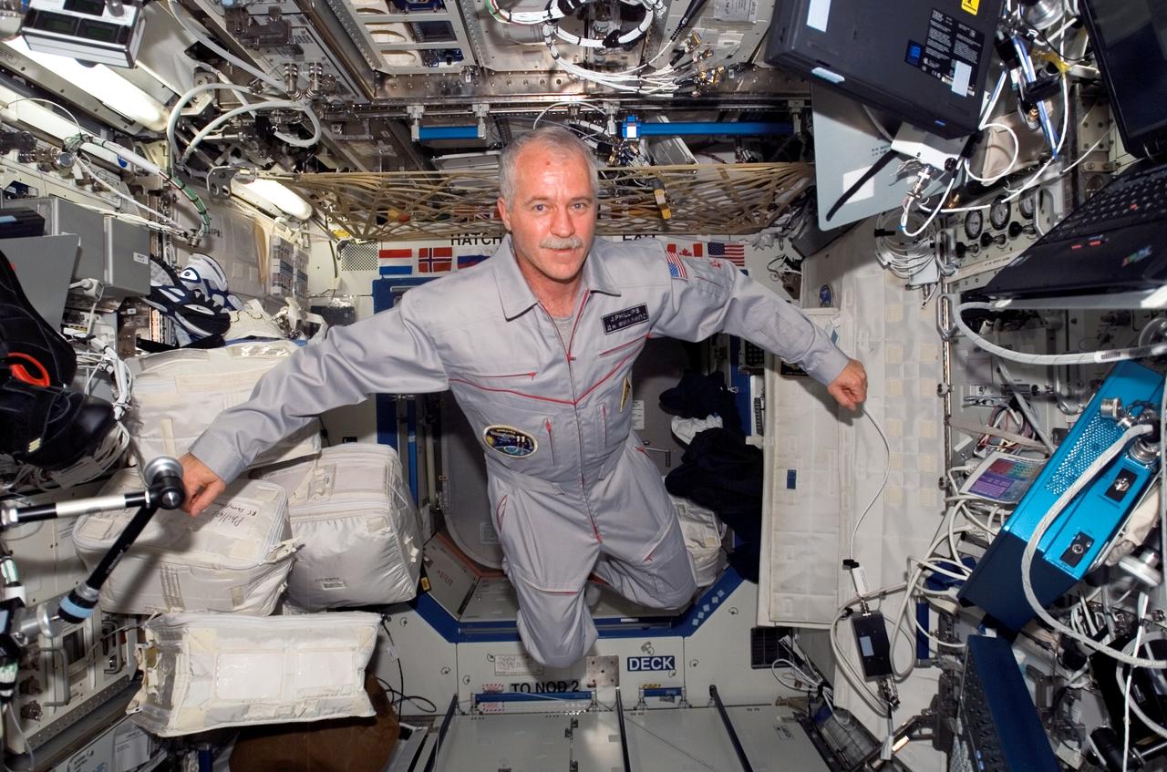 ISS011-E-05140 (17 April 2005) --- Astronaut John L. Phillips, Expedition 11 NASA science officer and flight engineer, floats in the Destiny laboratory of the international space station.