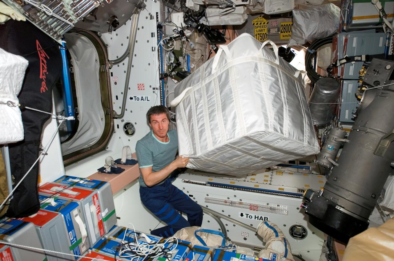 ISS011-E-06249 (18 May 2005) --- Cosmonaut Sergei K. Krikalev, Expedition 11 commander representing Russia's Federal Space Agency, moves un-stowed cargo through the Unity node from the PMA-2 (Pressurized Mating Adapter-2) in preparation for the scheduled docking of the space shuttle Discovery on international space station.