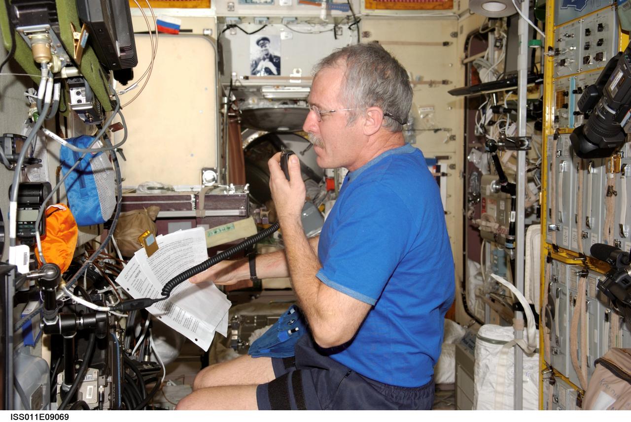 ISS011-E-09069 (2 June 2005) --- Astronaut John L. Phillips, Expedition 11 NASA ISS science officer and flight engineer, uses amateur radio equipment in the Zvezda Service Module of the International Space Station (ISS) while speaking with students from Brigidine College in Sydney, Australia.