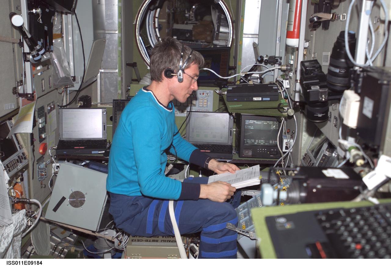 ISS011-E-09184 (18 June 2005) --- Cosmonaut Sergei K. Krikalev, Expedition 11 commander representing Russia's Federal Space Agency, practices docking procedures with the TORU teleoperated control system in the Zvezda Service Module of the International Space Station (ISS) in preparation for the docking of the Progress 18 spacecraft. Krikalev, using the Simvol-TS screen and hand controllers, could manually dock the Progress to the Station in the event of a failure of the Kurs automated docking system.