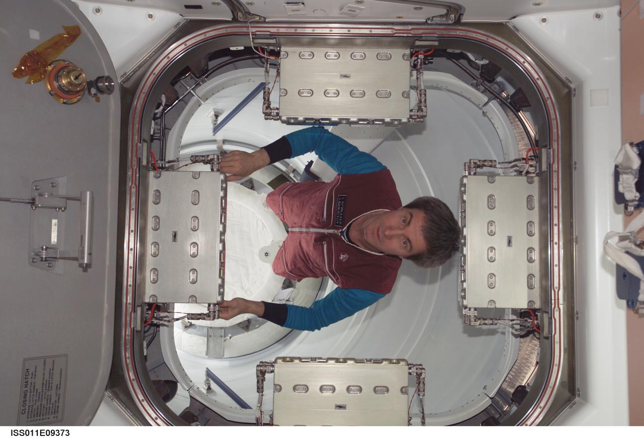 ISS011-E-09373 (21 June 2005) --- Cosmonaut Sergei K. Krikalev, Expedition 11 commander representing Russia's Federal Space Agency, prepares to uninstall two of the four Control Panel Assemblies (CPA) from the Unity node’s Common Berthing Assembly (CBA) on the International Space Station (ISS).