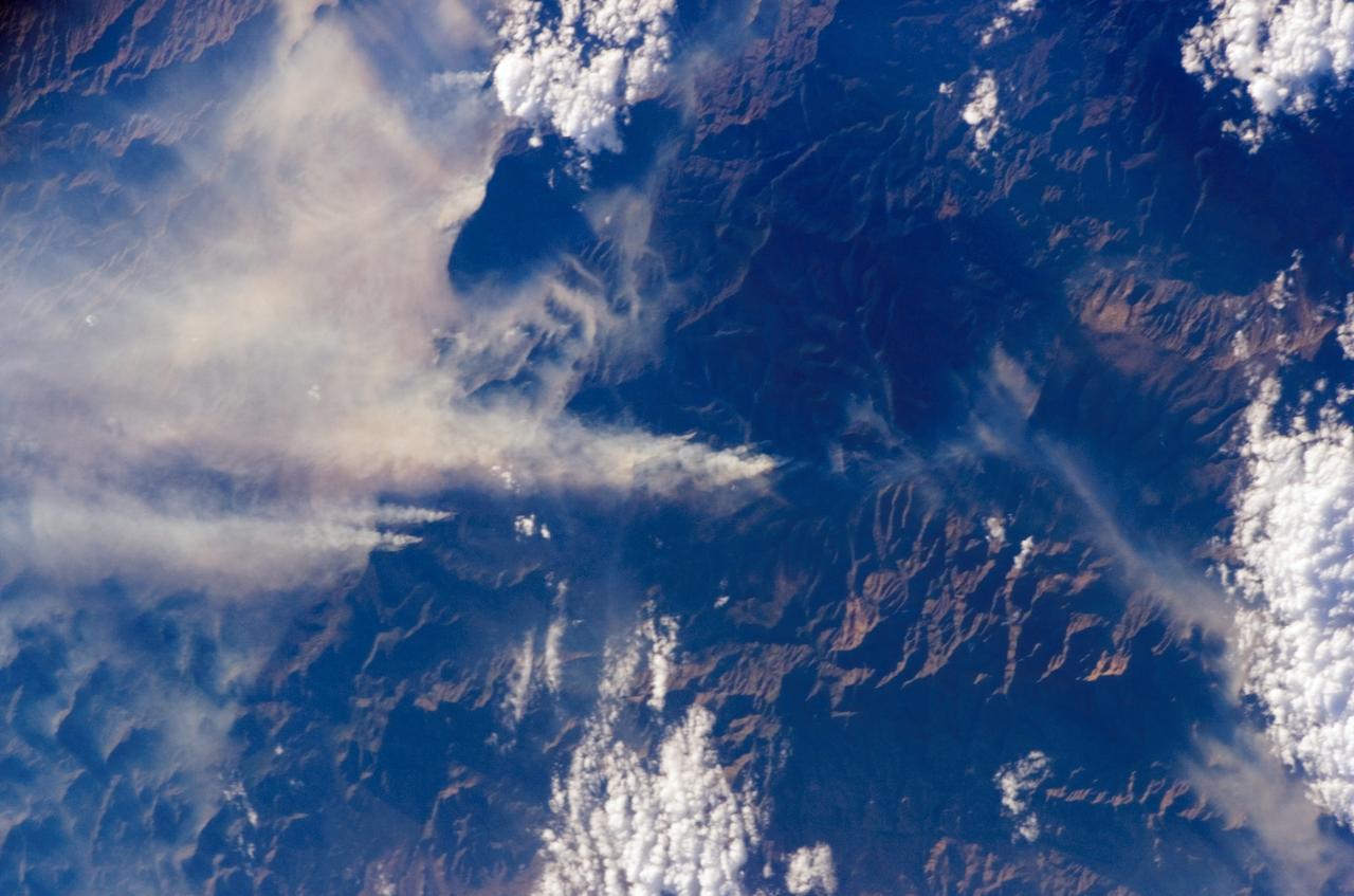 ISS011-E-09647 (27 June 2005) --- Lightning was the suspected cause of this giant wildfire, raging through an area northeast of Phoenix on Monday. This picture, taken shortly after 9 a.m. (CDT), is one of a series of images photographed by astronaut John L. Phillips, Expedition 11 flight engineer and NASA science officer, aboard the orbiting complex, flying at an altitude of 220 miles.