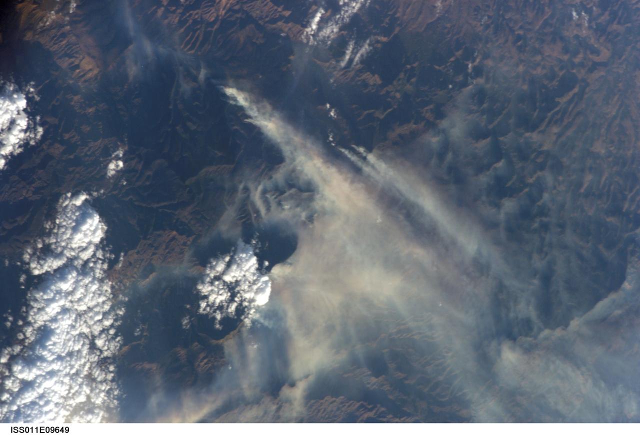ISS011-E-09649  (27 June 2005) --- Lightning was the suspected cause of this giant  wildfire, raging through an area northeast of Phoenix on Monday. This picture, taken shortly after 9 a.m. (CDT), is one of a series of images photographed by Astronaut John Phillips, Expedition 11 flight engineer and NASA ISS science officer, aboard the orbiting complex, flying at an altitude of 220 miles.