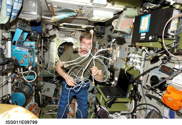 ISS011-E-09799 (27 June 2005) --- Cosmonaut Sergei K. Krikalev, Expedition 11 commander representing Russia's Federal Space Agency, works with the new Proximity Communications Equipment (PCE) hardware of the ASN-M satellite navigation system for the European Automated Transfer Vehicle (ATV) &#0147;Jules Verne&#0148; in the Zvezda Service Module of the International Space Station. The ATV is scheduled to arrive at the Station next year.