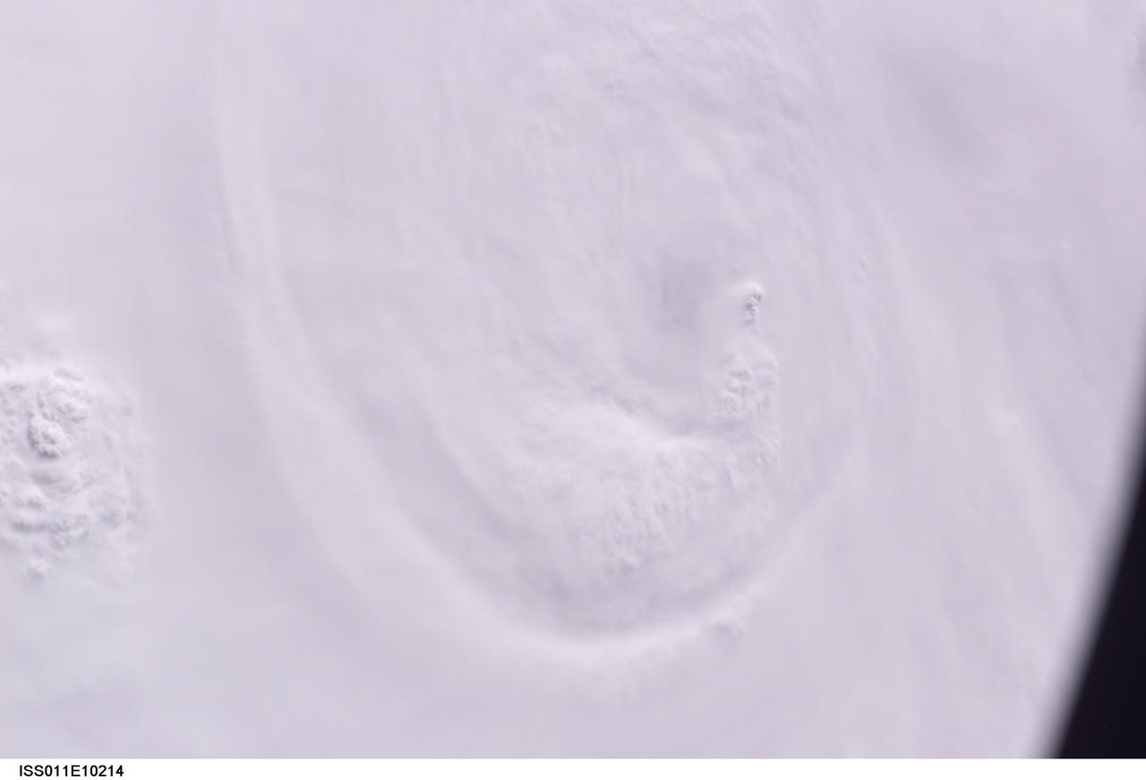 ISS011-E-10214 (7 July 2005) --- At the time of this Expedition 11 digital still camera's image, Hurricane Dennis was churning northwestward through the Caribbean Sea between Jamaica and eastern Cuba packing winds of up to 115 miles per hour. Even though the hurricane had just attained Category 3 intensity, the eye had not yet cleared. This oblique view, captured with a 70mm lens at 21:12:01 gmt, is looking west.