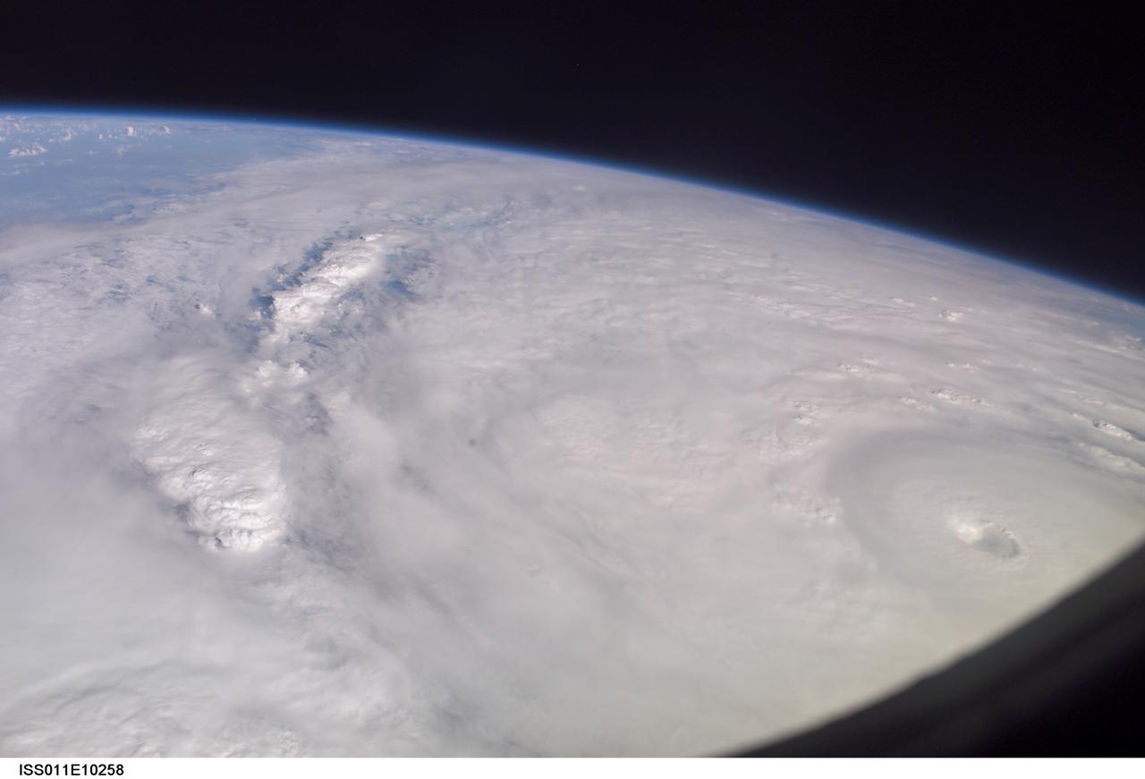 ISS011-E-10258 (9 July 2005)  --- This easterly-looking image from the International Space Station shows Hurricane Dennis after the storm had already crossed Cuba and was heading for the northern Gulf of Mexico. Dennis was a Category 3 storm, packing winds of 115 miles per hour, at the time of exposure and located approximately 385 miles southeast of Biloxi, Mississippi or 280 miles south of Panama City, Florida. The ill-defined eye is in the lower right corner. The black triangle in extreme lower right is part of the Space Station's window.