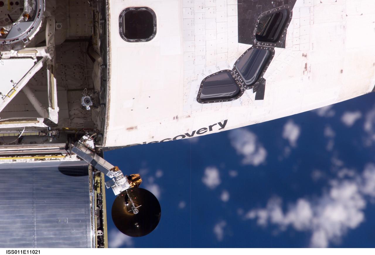ISS011-E-11021 (28 July 2005) --- View of the Space Shuttle Discovery's crew cabin and Ku-band antenna photographed during the mapping sequence by the Expedition 11 crew on the International Space Station during the STS-114 R-Bar Pitch Maneuver on Flight Day 3.
