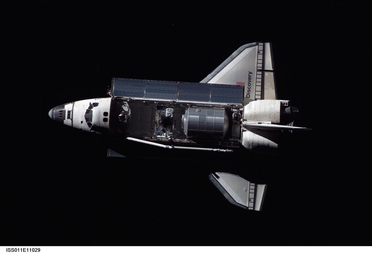 ISS011-E-11029 (28 July 2005) --- Overall view of the space shuttle Discovery as photographed during the survey operations performed by the Expedition 11 crew on the international space station during the STS-114 R-Bar Pitch Maneuver on Flight Day 3. The Italian-built Raffaello Multi-Purpose Logistics Module (MPLM) is visible in the cargo bay.