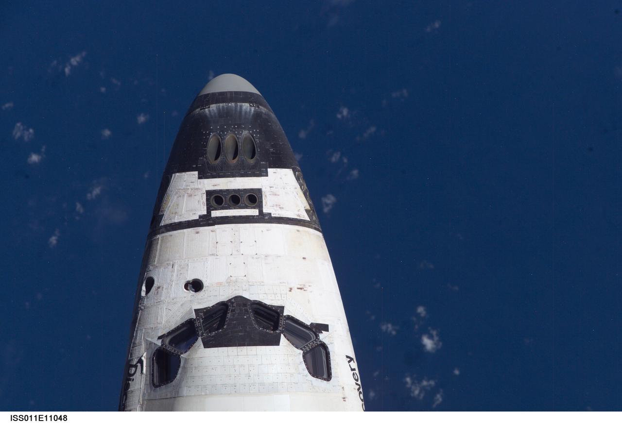 ISS011-E-11048 (28 July 2005) --- The crew cabin of the Space Shuttle Discovery was photographed by the crewmembers of the International Space Station as the two spacecraft approached each other for docking on July 28, 2005.  The Expedition 12 crewmembers onboard the orbital outpost took a battery of survey photographs of the Shuttle thermal protection system.