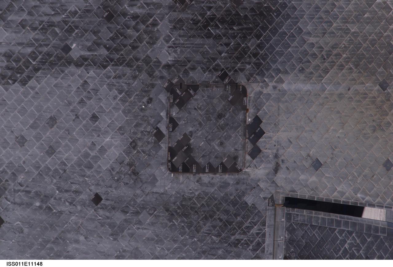 ISS011-E-11148 (28 July 2005) --- View of the Space Shuttle Discovery's underside (near the Orbital Maneuvering System pod), photographed as part of  the survey sequence performed by the Expedition 11 crew during the STS-114 R-Bar Pitch Maneuver on Flight Day 3.  This picture was used by Steve M. Poulos, Jr.  Manager, Space Shuttle Vehicle Engineering Office, as one of his visual aids in a July 28, 2005 press conference in the Teague Auditorium at the Johnson Space Center.