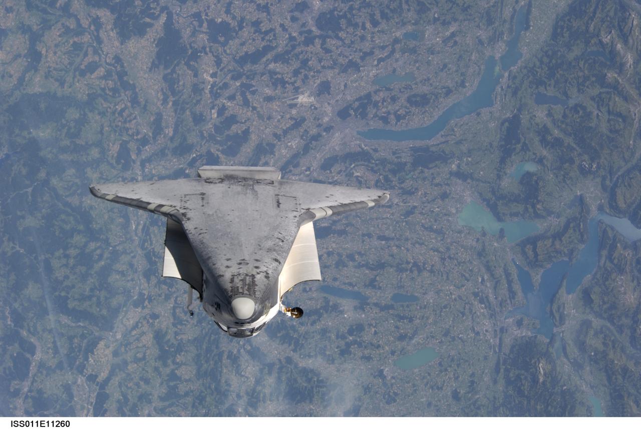 ISS011-E-11260 (28 July 2005) --- This underside view of the Space Shuttle Discovery was photographed by cosmonaut Sergei K. Krikalev, Expedition 11 commander, and astronaut John L. Phillips, NASA Space Station science officer and flight engineer, as Discovery approached the International Space Station and performed a backflip to allow photography of its heat shield. Astronaut Eileen M. Collins, STS-114 commander, guided the Shuttle through the flip. The photos will be analyzed by engineers on the ground as additional data to evaluate the condition of Discovery’s heat shield.