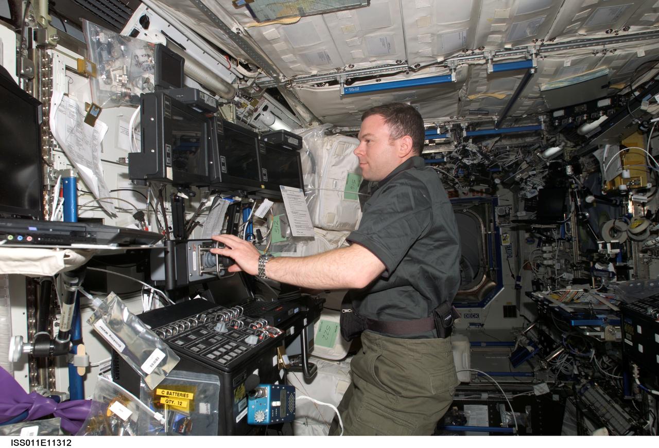 ISS011-E-11312 (29 July 2005) --- Astronaut James M. Kelly, STS-114 pilot, controls the Space Station Remote Manipulator System (Canadarm2)  from the U.S. Lab, Destiny, on the International Space Station.