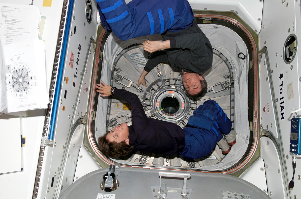 ISS011-E-11317 (29 July 2005) --- Russian Federal Space Agency cosmonaut Sergei K. Krikalev, Expedition 11 commander, and astronaut Wendy B. Lawrence, STS-114 mission specialist, prepare to unload the Raffaello Multi-Purpose Logistics Module (MPLM) docked to the international space station.