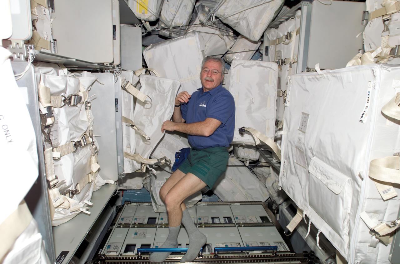 ISS011-E-11364 (31 July 2005) --- Astronaut John L. Phillips, Expedition 11 NASA Space Station science officer and flight engineer, participates in the movement of supplies and equipment inside Raffaello, the Italian Space Agency-built Multipurpose Logistics Module (MPLM) to the international space station.
