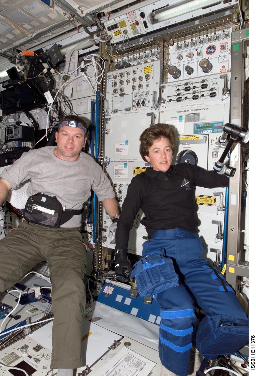 ISS011-E-11376 (31 July 2005) --- Astronauts James M. Kelly (left), STS-114 pilot, and Wendy B. Lawrence, mission specialist, are photographed after installing the new Human Research Facility (HRF) rack 2 in the Destiny laboratory of the International Space Station.