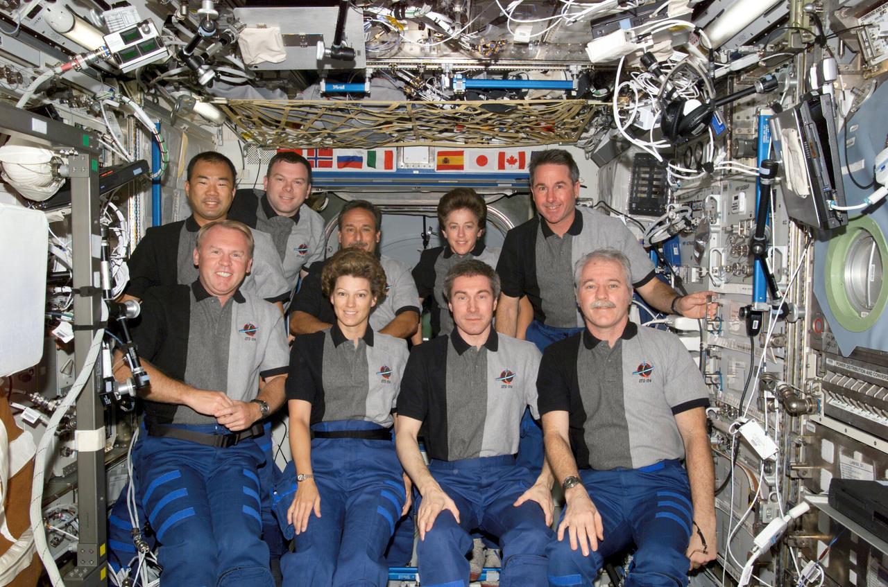 ISS011-E-11403 (2 August 2005) --- The Expedition 11 and STS-114 crewmembers gather for a group photo in the Destiny laboratory of the international space station. From the left (front row) are astronauts Andrew S. W. Thomas, STS-114 mission specialist; Eileen M. Collins, STS-114 commander; cosmonaut Sergei K. Krikalev, Expedition 11 commander representing Russia's Federal Space Agency; astronaut John L. Phillips, Expedition 11 NASA Space Station science officer and flight engineer. From the left (back row) are astronauts Soichi Noguchi, STS-114 mission specialist representing Japan Aerospace Exploration Agency (JAXA); James M. Kelly, STS-114 pilot; Charles J. Camarda, Wendy B. Lawrence and Stephen K. Robinson, all STS-114 mission specialists.