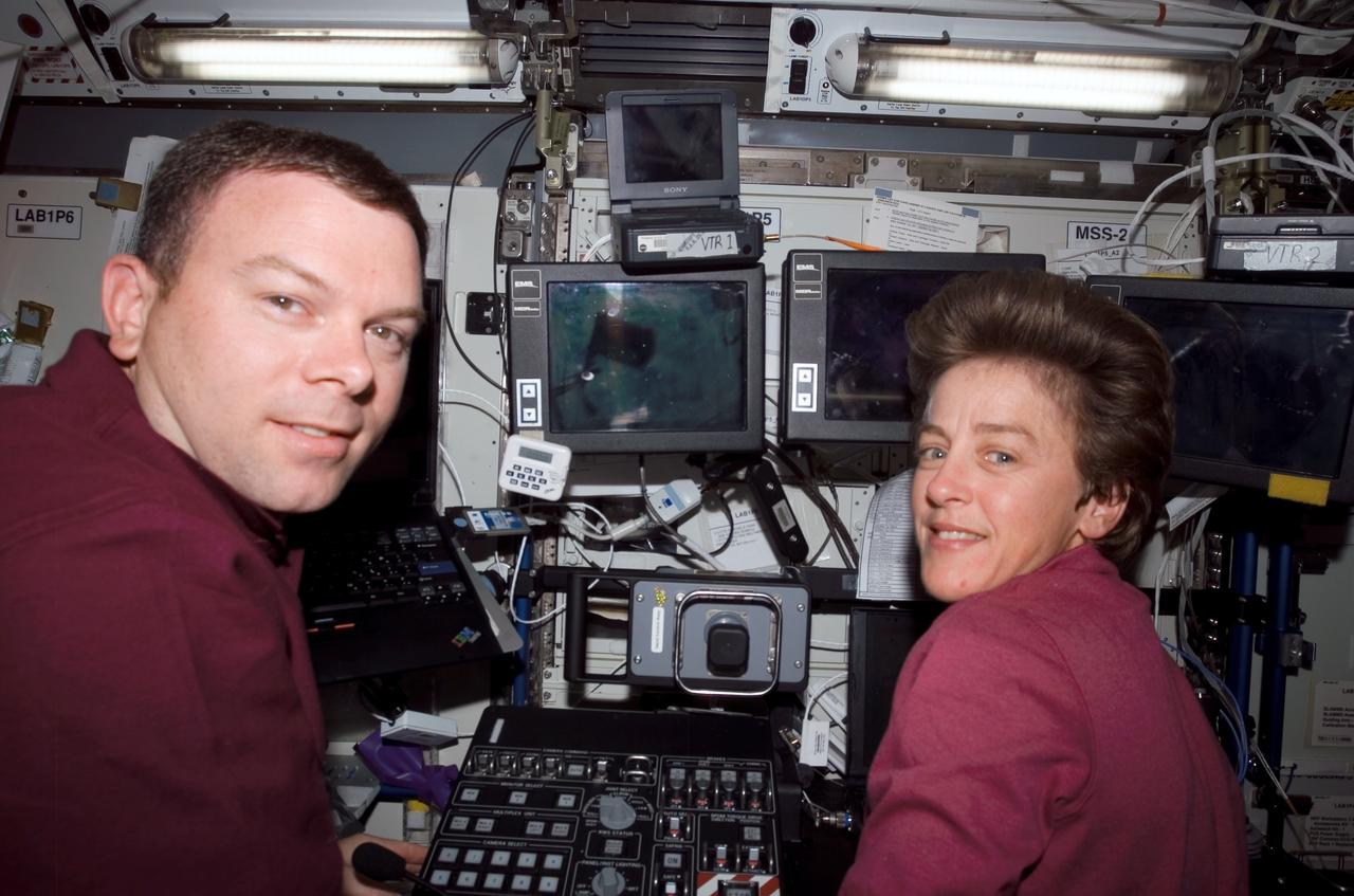 ISS011-E-11515 (5 August 2005) --- On the early Friday morning agenda for Astronauts James M. Kelly, pilot, and Wendy B. Lawrence, mission specialist, was important robotics duty at the controls of the Canadarm2 in the U.S. Lab, Destiny, on the International Space Station. Several digital photos in this sequence reveal the focal point of their work on the other end of the arm as the Italian-built Multi-Purpose Logistics Module Raffaello. The MPLM was being moved from its temporary parking place on the Station's Unity node to the payload bay of Discovery. The astronauts had arrived nine days ago with tons of fresh supplies for the Station, and with much effort, replaced that space on Raffaello with unneeded materials from the orbital outpost.