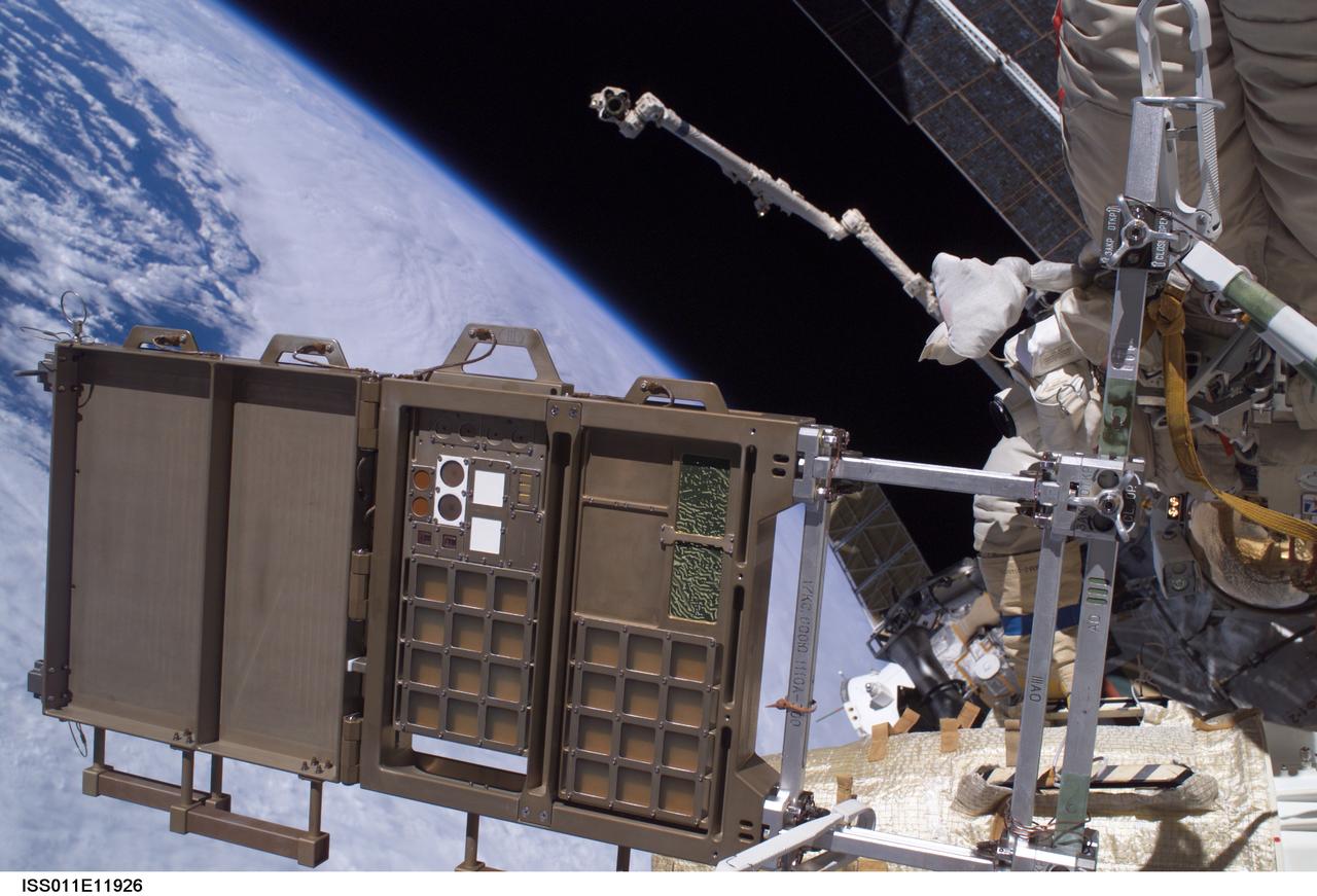 ISS011-E-11926 (18 Aug. 2005) --- View of a Micro-Particles Capturer (MPAC) and Space Environment Exposure Device (SEED) panel photographed prior to removal from the exterior of the Zvezda Service Module of the International Space Station during a session of extravehicular activity (EVA) conducted by the Expedition 11 crew (out of frame). Earth;s horizon and the blackness of space provided the backdrop for this scene.