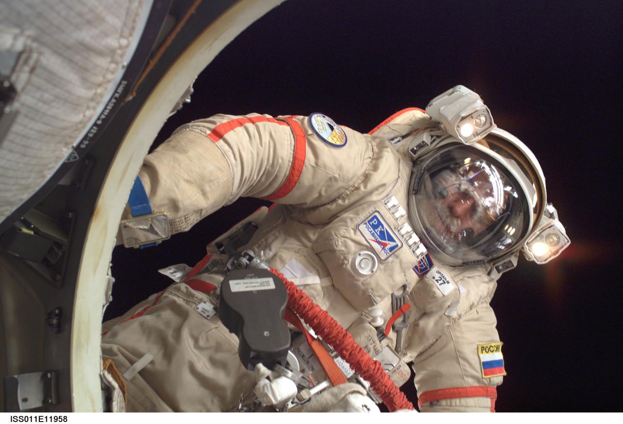 ISS011-E-11958 (18 August 2005) --- Attired in a Russian Orlan spacesuit, astronaut John L. Phillips, Expedition 11 NASA Space Station science officer and flight engineer, participates in a session of extravehicular activity (EVA). The 4 hour 58 minute spacewalk by Phillips and cosmonaut Sergei K. Krikalev (out of frame), commander representing Russia's Federal Space Agency, was the 62nd EVA in support of Station assembly and maintenance, the 34th conducted from the Station itself, and the 16th from the Pirs Docking Compartment.