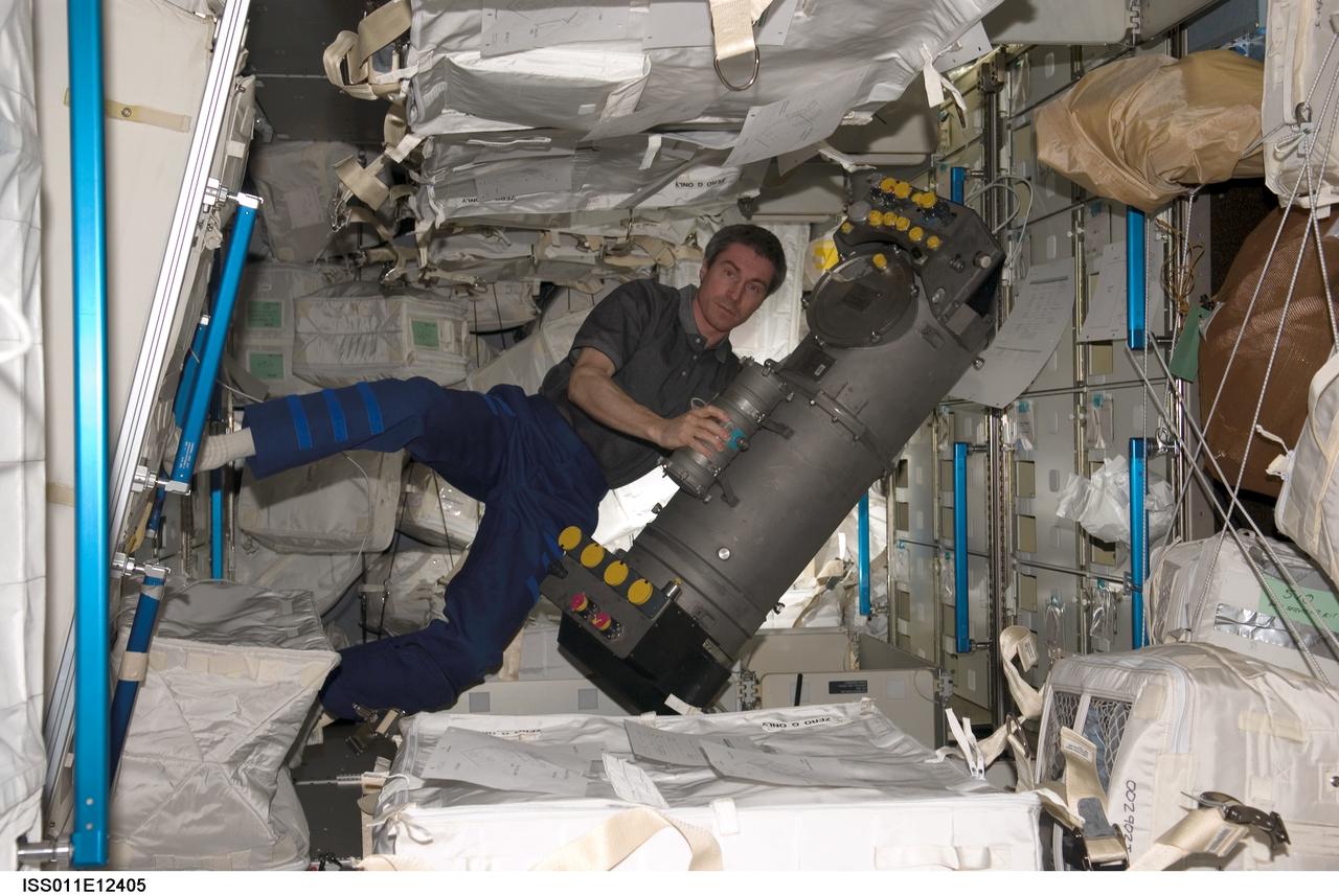 ISS011-E-12405 (31 July 2005) --- Cosmonaut Sergei K. Krikalev, Expedition 11 commander representing Russia's Federal Space Agency, holds the Elektron oxygen-generation system in the Italian-built Raffaello Multi-Purpose Logistics Module (MPLM) docked to the International Space Station during the STS-114 mission.