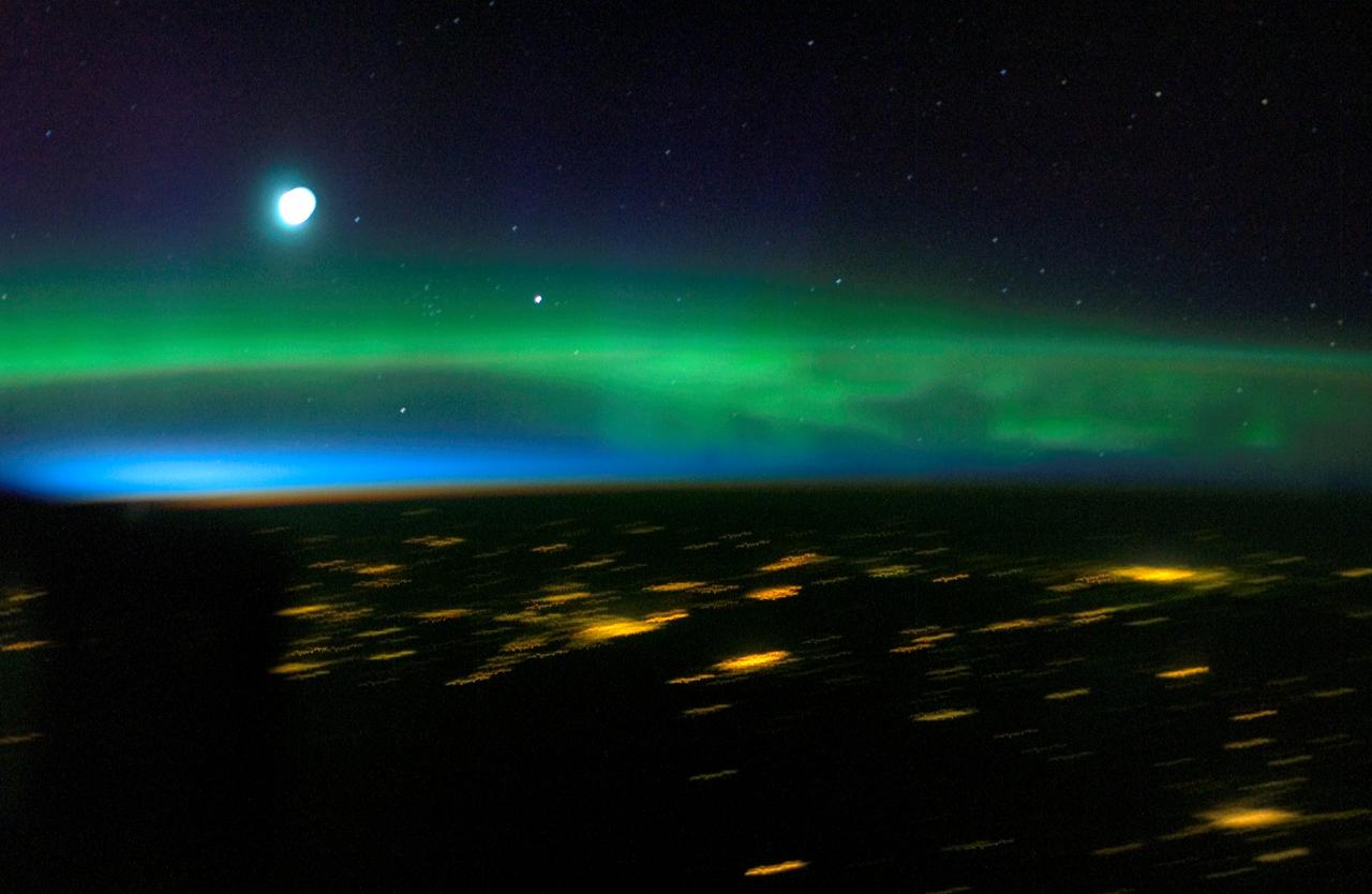 ISS011-E-12415 (31 August 2005) --- Aurora Borealis and lights in Finland, Russia, Estonia and Latvia are featured in this digital still picture taken by the Expedition 11 crew aboard the international space station. If it were daylight parts of the Eastern Baltic Sea would be visible. The station was over a point on Earth located at 50.6 degrees north latitude and 15.1 degees east longitude at the time. The cluster of stars to the lower right of the thin crescent Moon is the Praesepe or Beehive Cluster in Cancer. Just to the right of that is the planet Saturn.